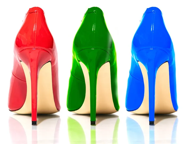 Female shiny colored stilettos on a white background — 图库照片