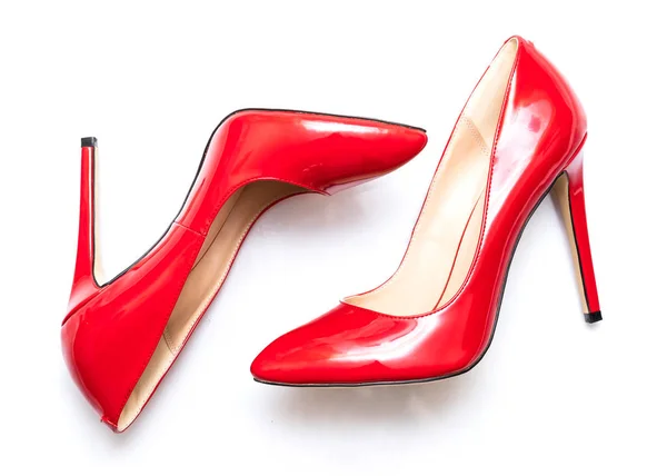 female shiny red stilettos on a white background