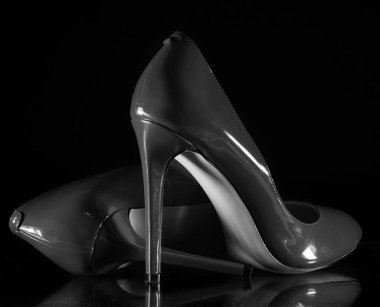 patent leather shiny female gray stilettos on a black background