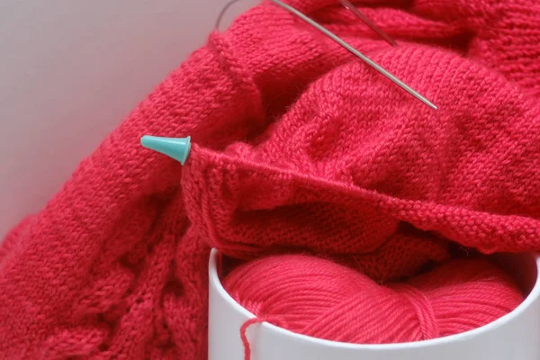 knitting a warm sweater and wool yarn