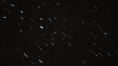 fast flying heavy snow at night. blizzard against the black sky