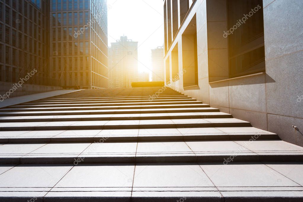 footpath between modern building with sunbeam