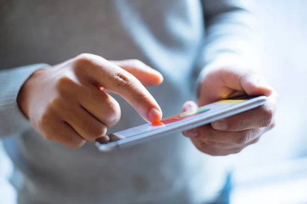 Pessoa usando telefone celular com gráfico de finanças — Fotografia de Stock