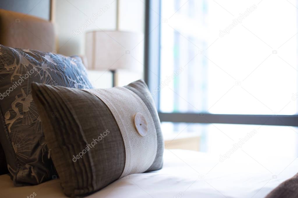 pillows on comfortable bed in modern bedroom