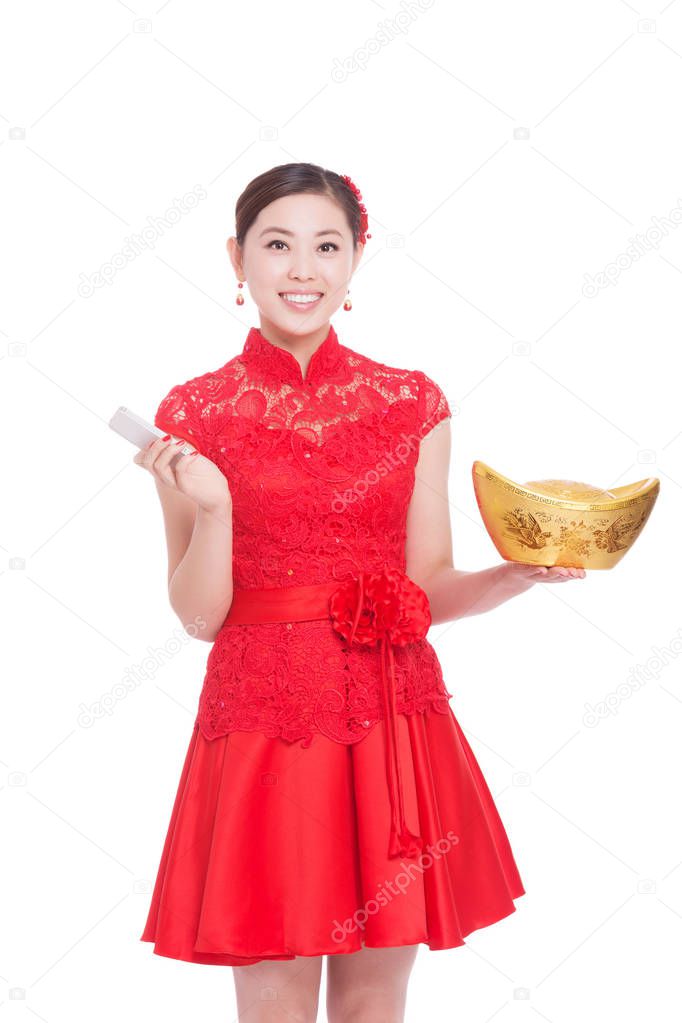 woman holds gold ingot and mobile phone in chinese new year