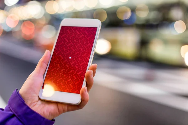 Mobile phone in hand with abstract pattern — Stock Photo, Image