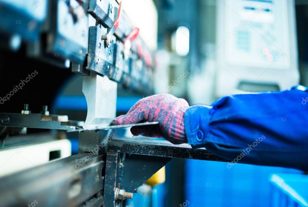 person controls manufacturing machine