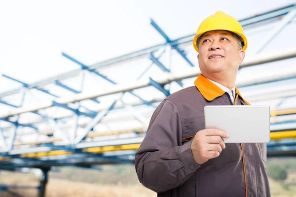 engineer with tablet on oil refinery plant