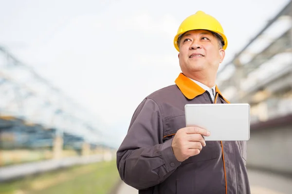 engineer with tablet on oil refinery plant