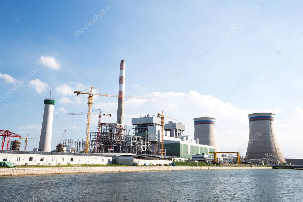 modern power plant near river 