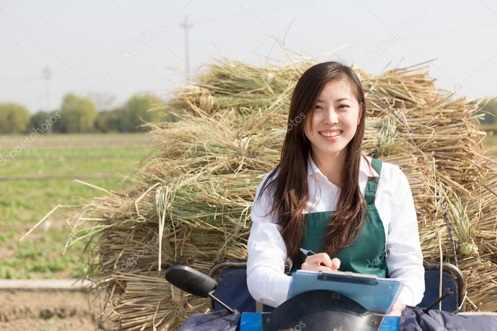woman agronomist working on motocycle with straw