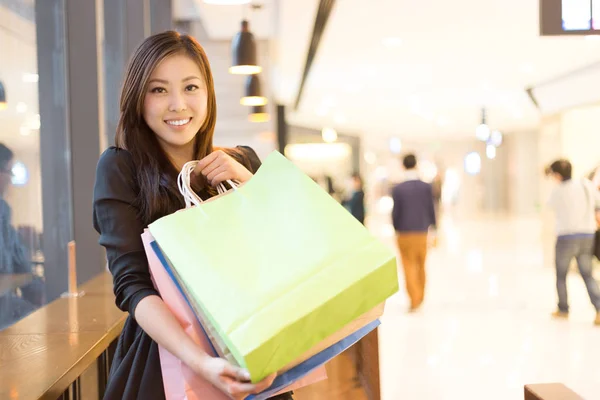 asian woman shopping in shopping mall