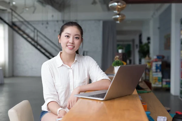 Ung vacker kvinna slappnar av i office — Stockfoto