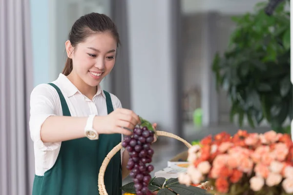 pretty woman works in fruit store