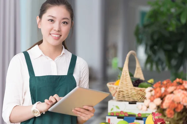 Pretty woman works in fruit store — Stock Photo, Image