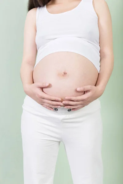 Pretty woman holds her belly — Stock Photo, Image