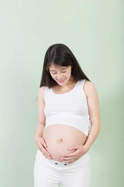 Pretty woman holds her belly — Stock Photo, Image