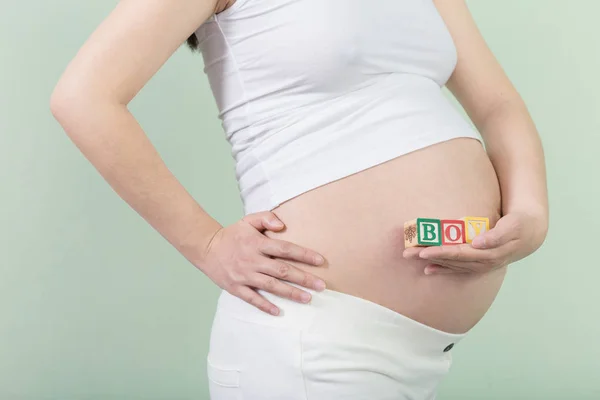 Young pretty pregnant woman with cubes — Stock Photo, Image