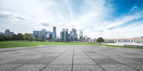 Empty brick floor and cityscape of modern city — Stock Photo, Image