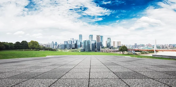 Empty brick floor and cityscape of modern city — Stock Photo, Image