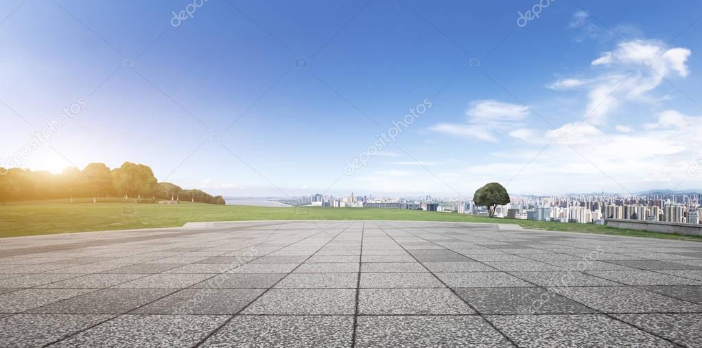 empty brick floor and cityscape of modern city