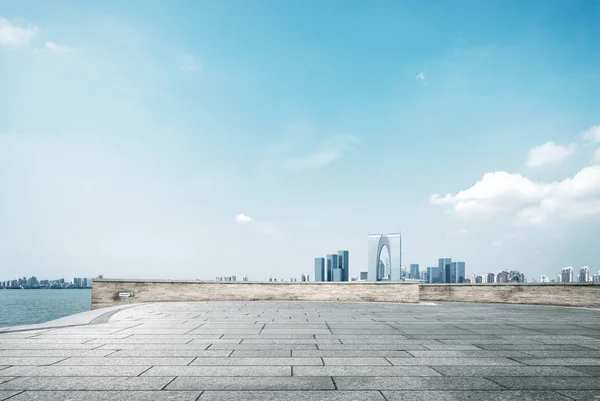 Prázdné cihlová podlaha a panoráma moderního města — Stock fotografie