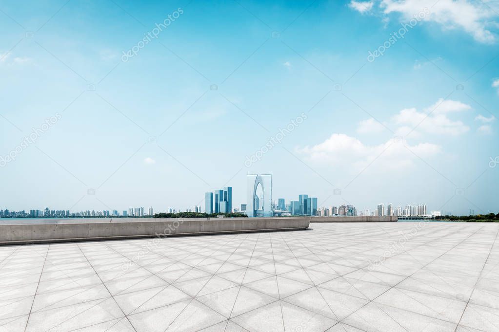 empty brick floor and cityscape of modern city