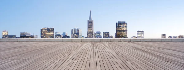 Wooden floor with cityscape of modern city — Stock Photo, Image