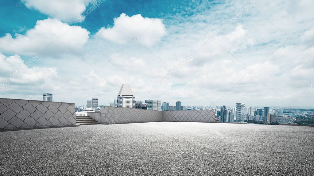 cityscape of modern city from empty road in cloud sky