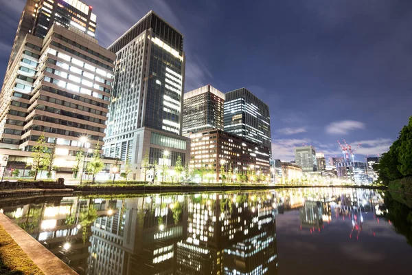 Moderne gebouwen door rivier in schemerlicht — Stockfoto