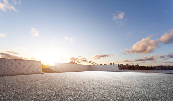 landmark sydney bridge and Sydney Opera House from empty road at sunrise