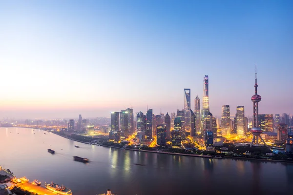 Modern buildings near river at sunrise — Stock Photo, Image