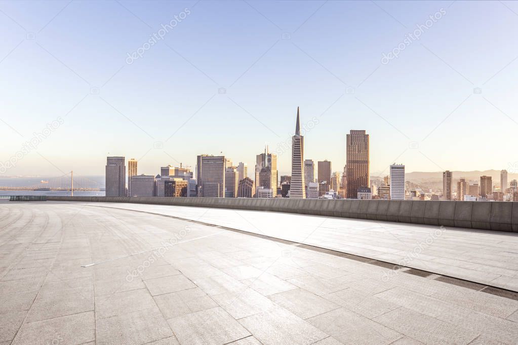 empty brick floor with cityscape of San Francisco at sunrise