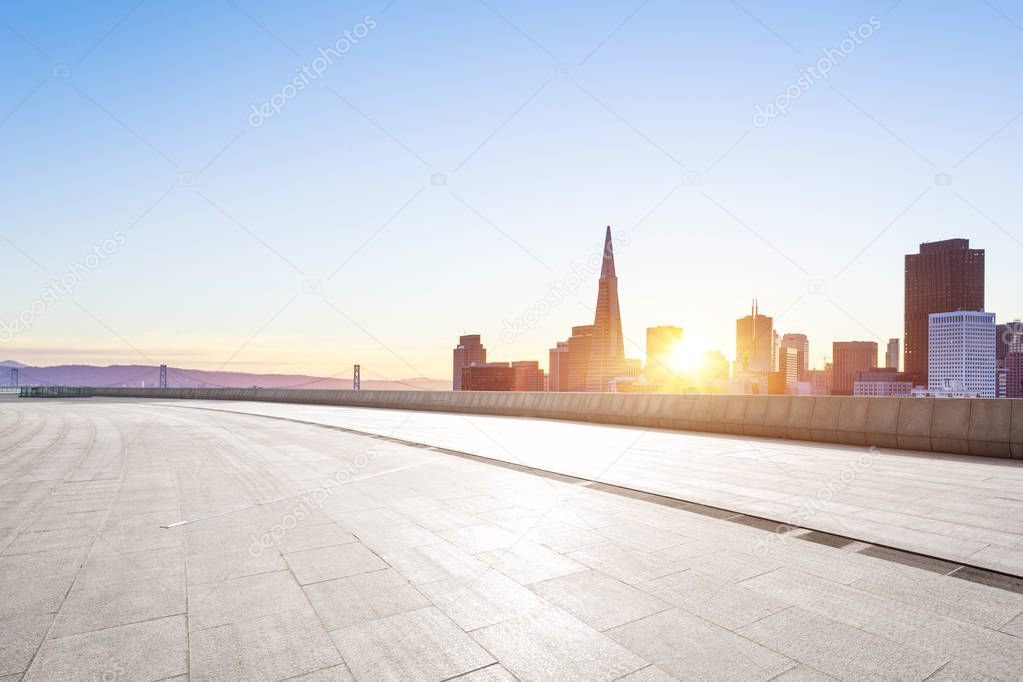 empty brick floor with cityscape of San Francisco at sunrise