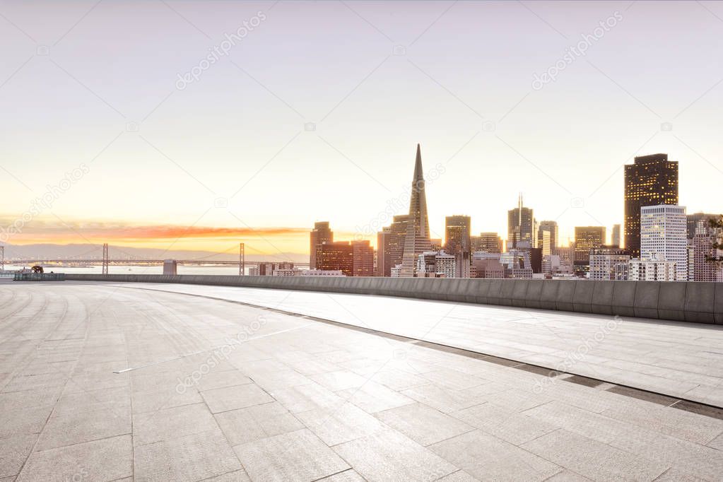 empty brick floor with cityscape of San Francisco at sunrise