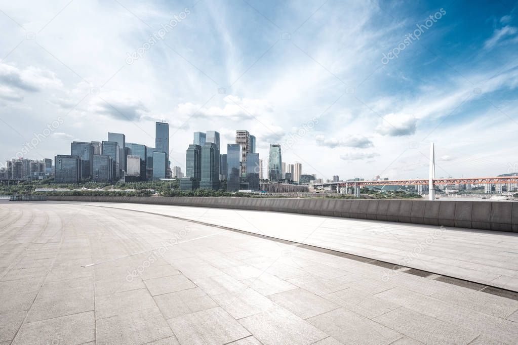 empty brick floor with cityscape of modern city