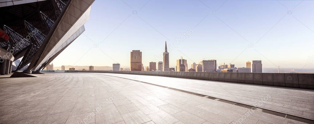 empty brick floor with cityscape of San Francisco at sunrise