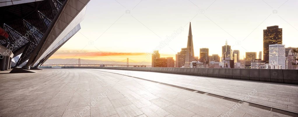 empty brick floor with cityscape of San Francisco at sunrise