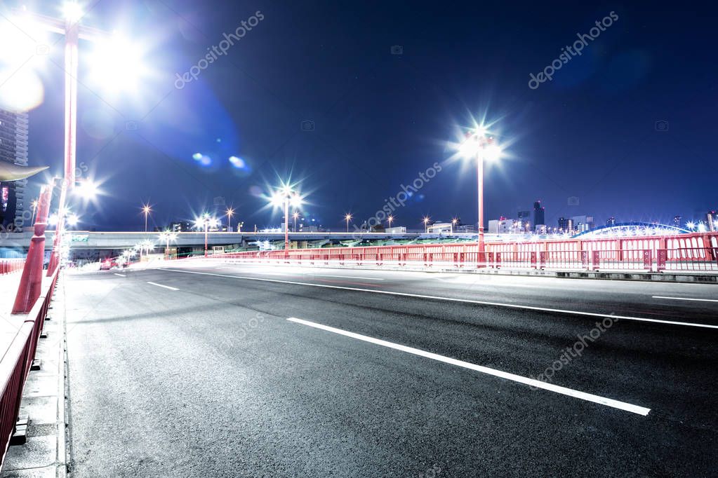 empty road with cityscape of Tokyo at night