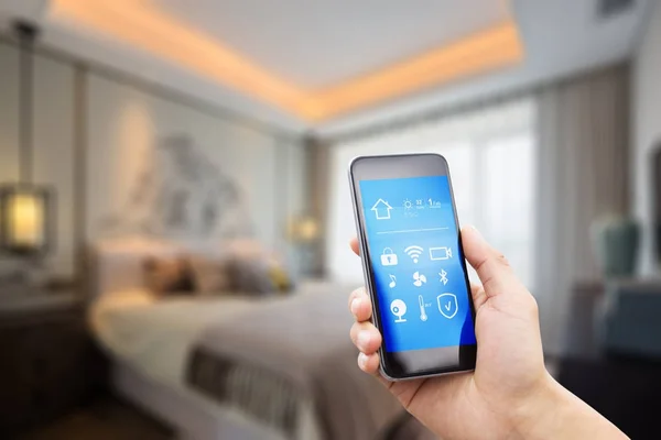 Mobile phone in modern bedroom — Stock Photo, Image