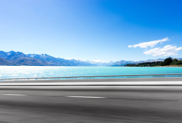 empty asphalt road near lake