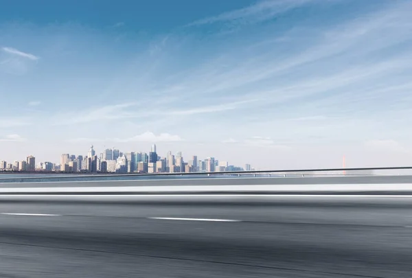 Asphalt road with cityscape of modern city — Stock Photo, Image