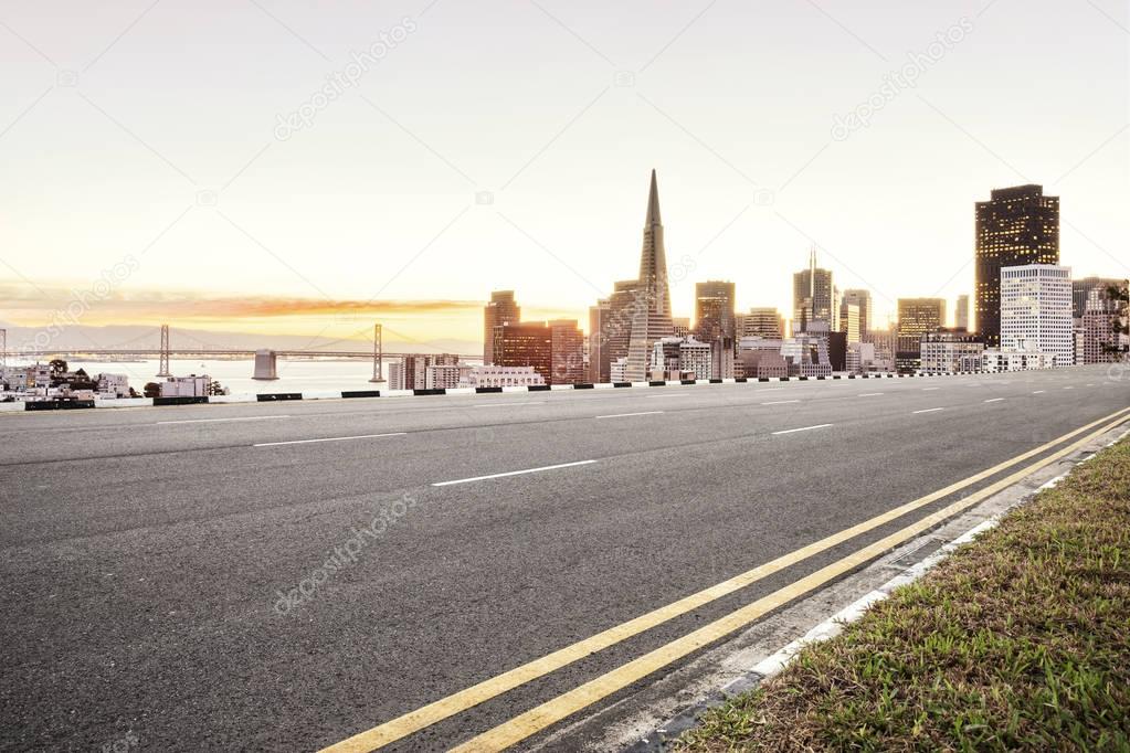 empty asphalt road and cityscape 
