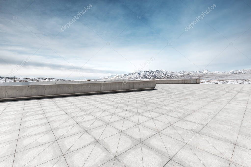 empty floor with white snow mountain