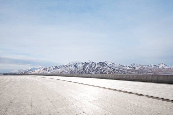 empty marble floor with snow mountains