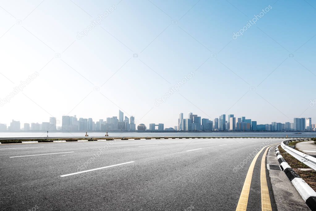 asphalt road with cityscape of modern city