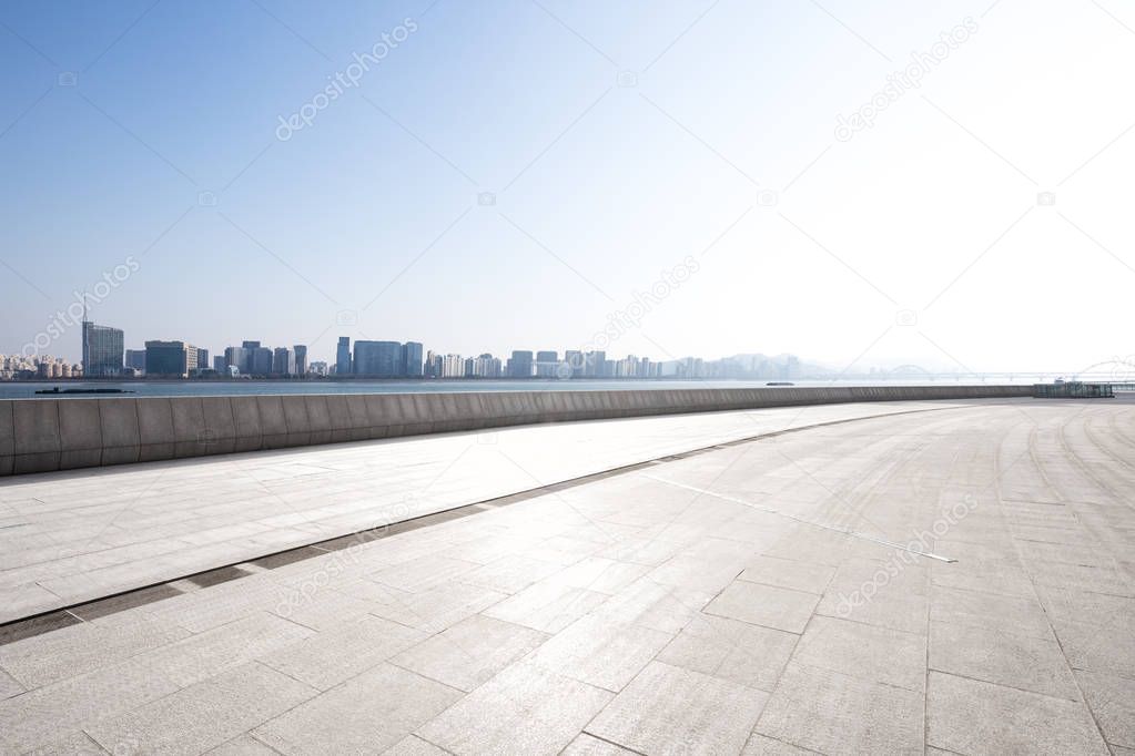 empty marble floor and cityscape of Hangzhou in cloud sky