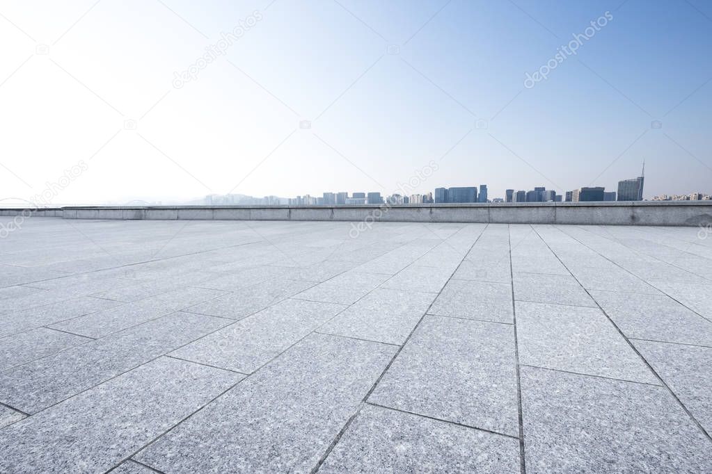 empty marble floor and cityscape of Hangzhou in cloud sky