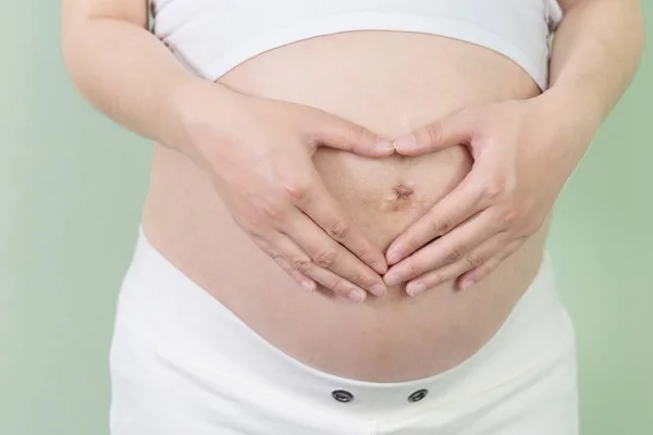 Pretty woman holds her belly — Stock Photo, Image