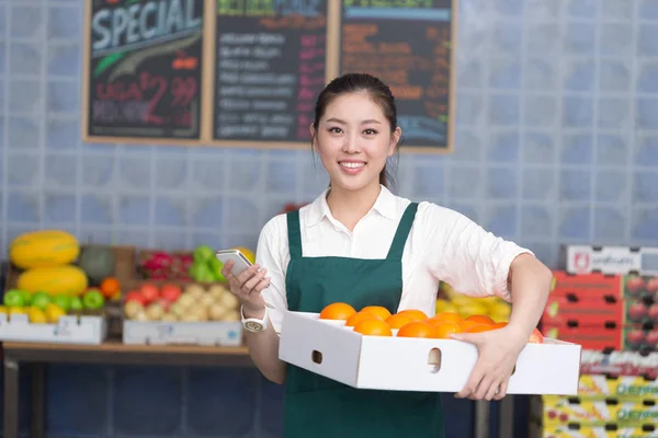 pretty woman works in fruit store